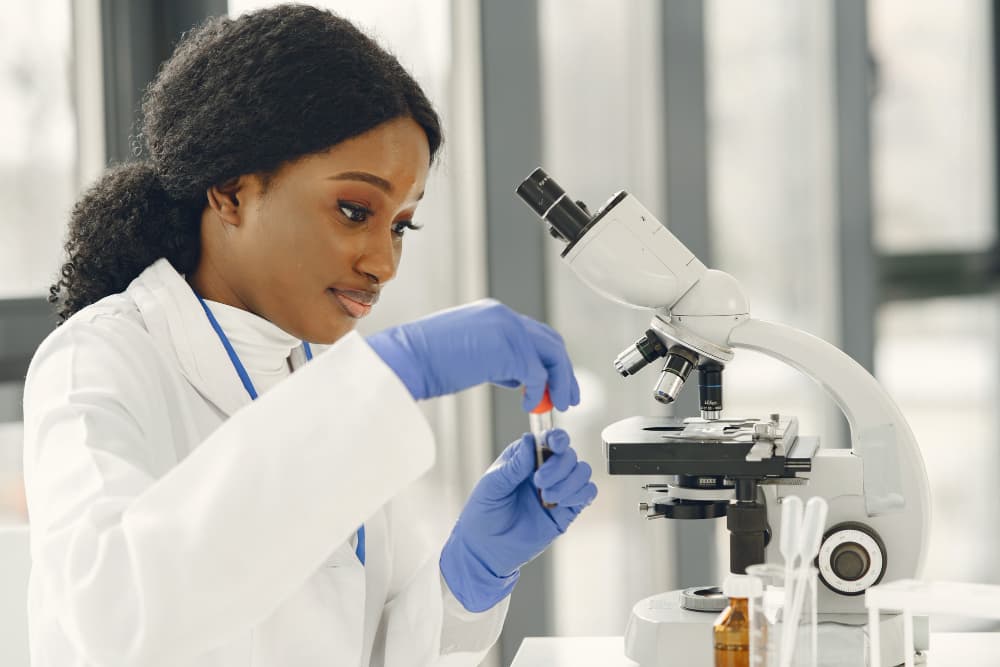 A researcher examining a sample in the lab